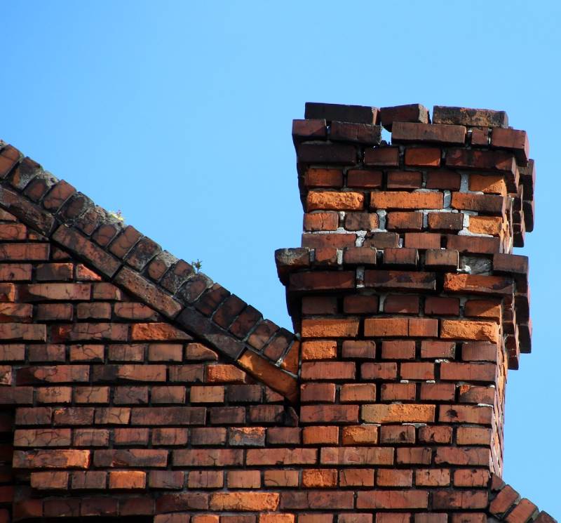 Damaged chimney on an Revere home showing cracks and missing mortar